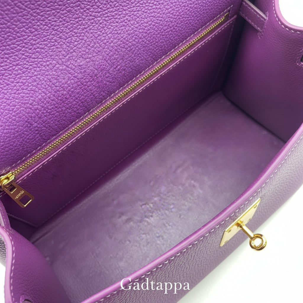 Close-up of a purple leather bag with gold zipper