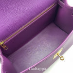 Close-up of a purple leather bag with gold zipper