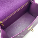 Close-up of a purple leather bag with gold zipper